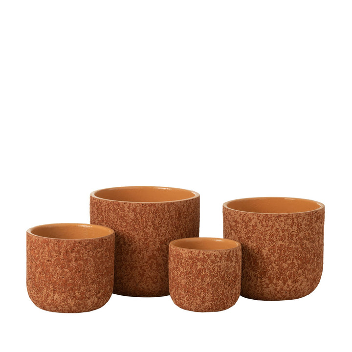 Group view of Rustic Pot Orange ceramic planters in various sizes.