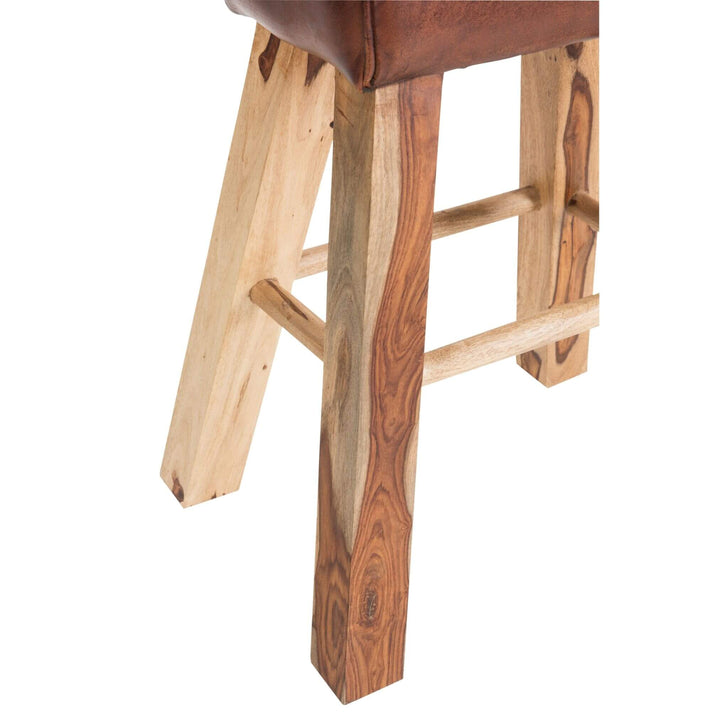 Close-up of brown leather seat and wooden legs on Rock Bar Stool