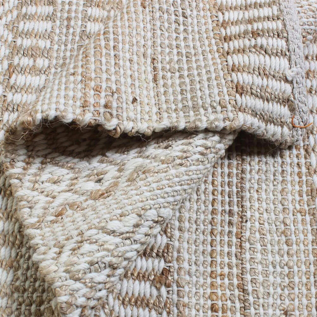 Folded edge detail of the Sadar Rug showing texture and material thickness.