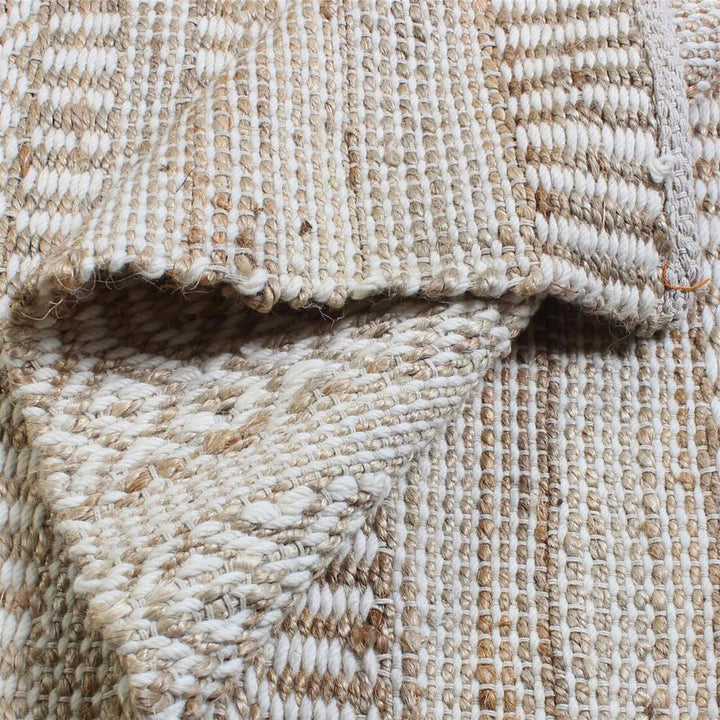 Folded edge detail of the Sadar Rug showing texture and material thickness.