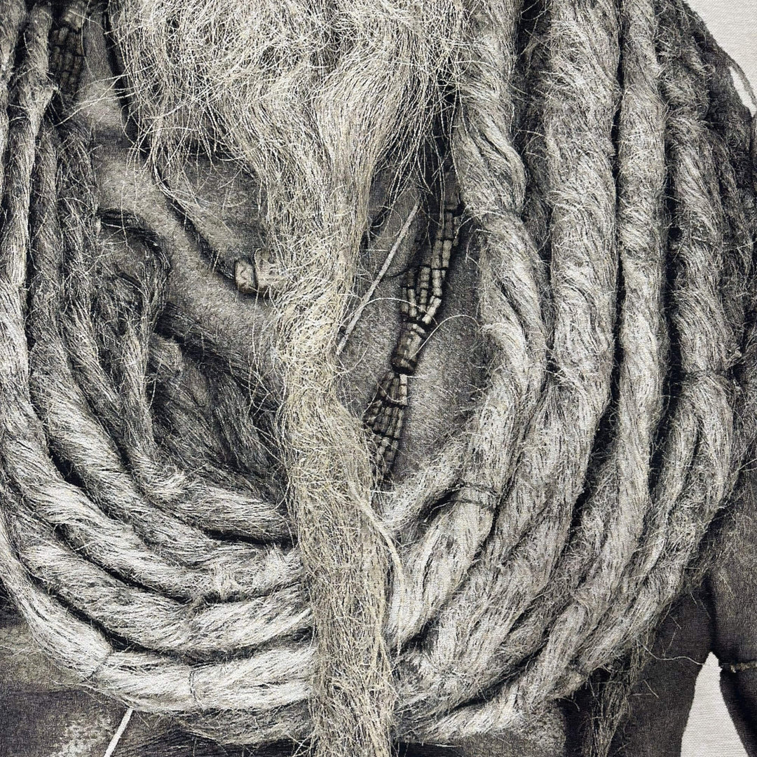 Close-up detail of the tapestry highlighting the textured fabric and intricate hair and beard details.