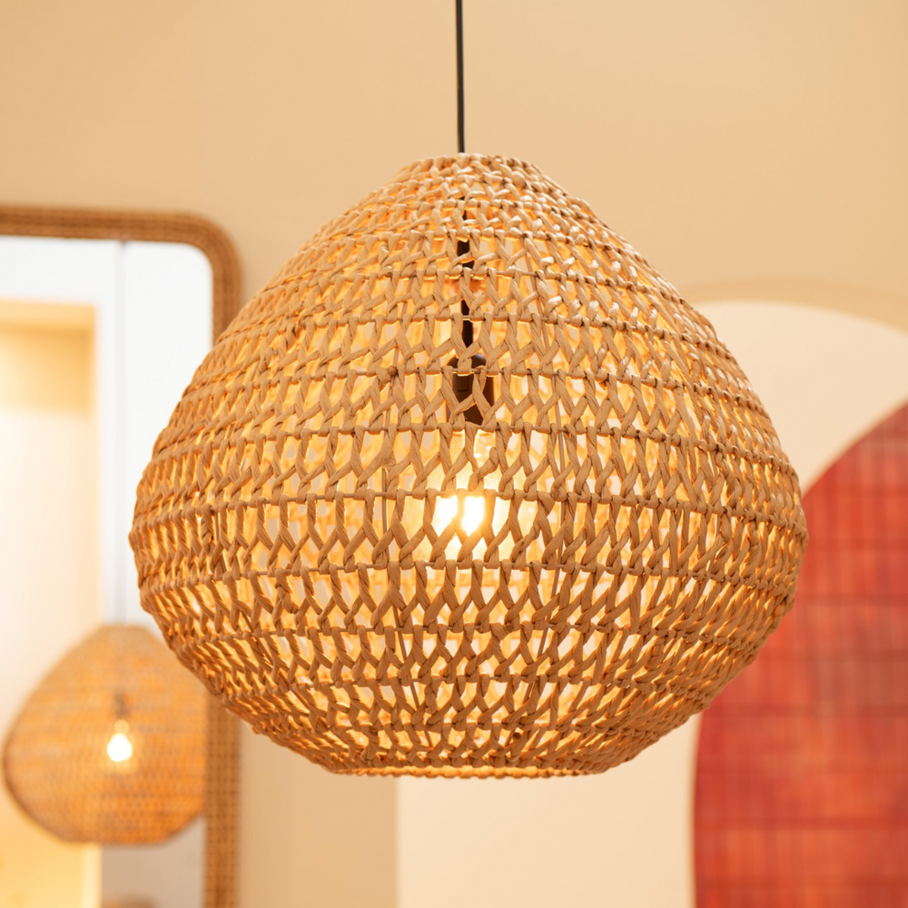 Sahana terracotta pendant styled above a dining area, lifestyle scene.