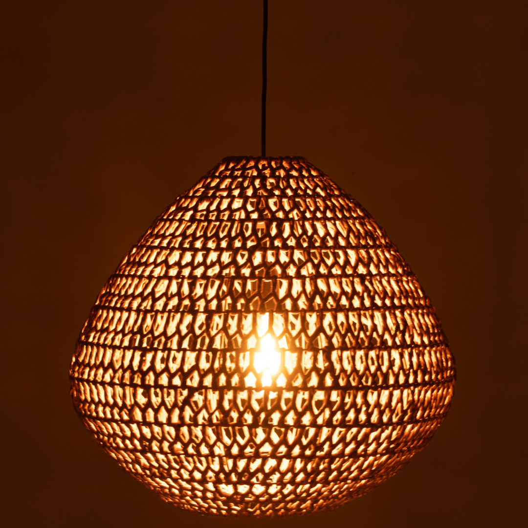 Close-up of illuminated Sahana natural pendant showing open-weave pattern.