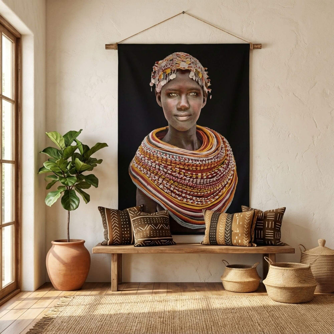 Styled interior scene showcasing the Samburu Girl tapestry as a statement wall hanging above a wooden bench.