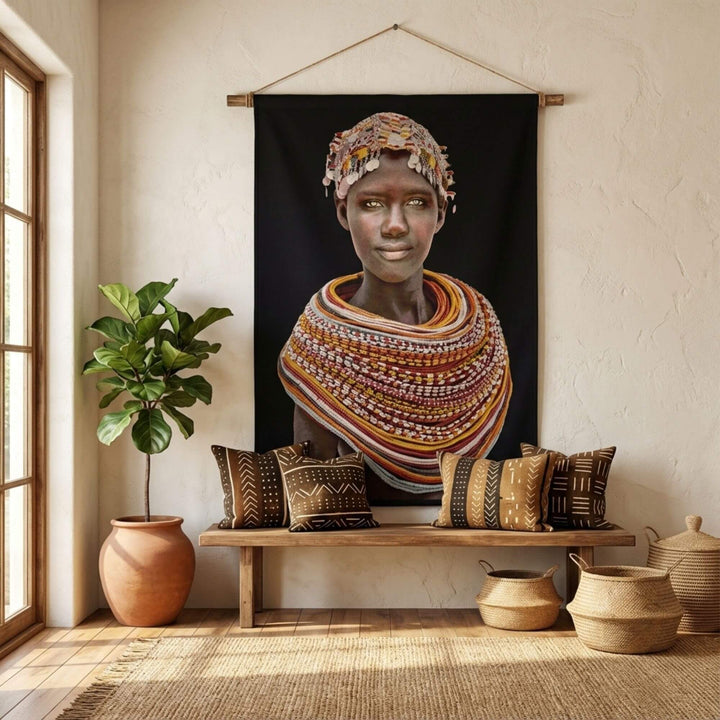 Styled interior scene showcasing the Samburu Girl tapestry as a statement wall hanging above a wooden bench.