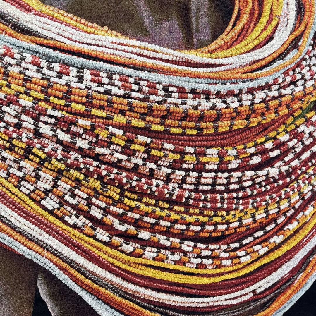 Close-up detail of the colorful beaded necklace pattern printed on the Samburu Girl fabric tapestry.
