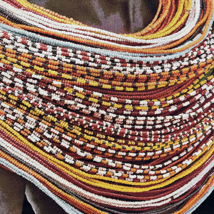 Close-up detail of the colorful beaded necklace pattern printed on the Samburu Girl fabric tapestry.