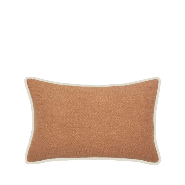 Front view of the Sandline cushion showing its rectangular shape, terracotta washed cotton fabric, and neutral border.