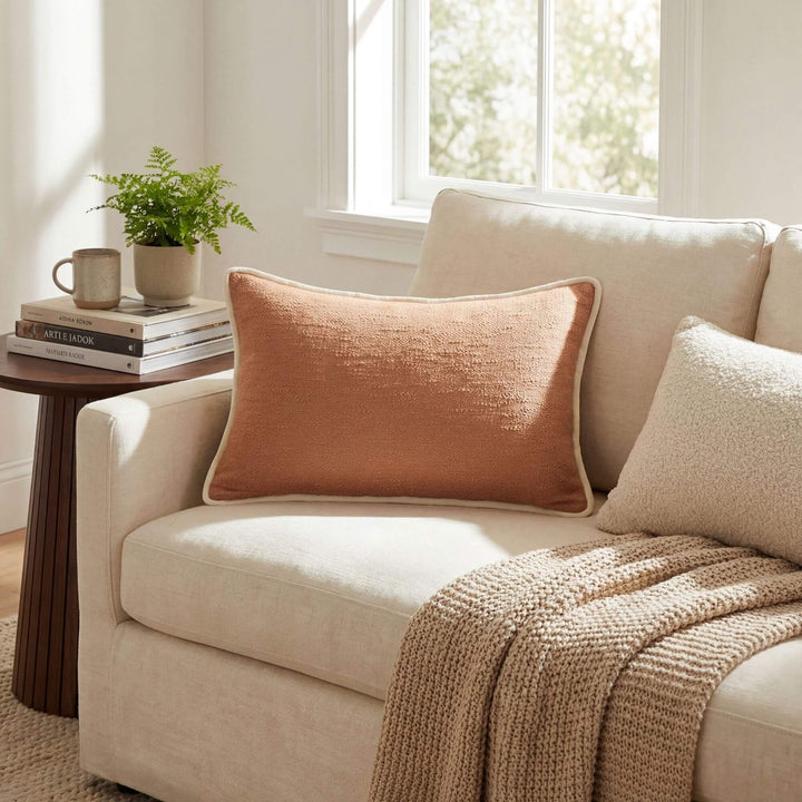 Styled interior setting featuring the Sandline cushion on a sofa with soft natural textiles.
