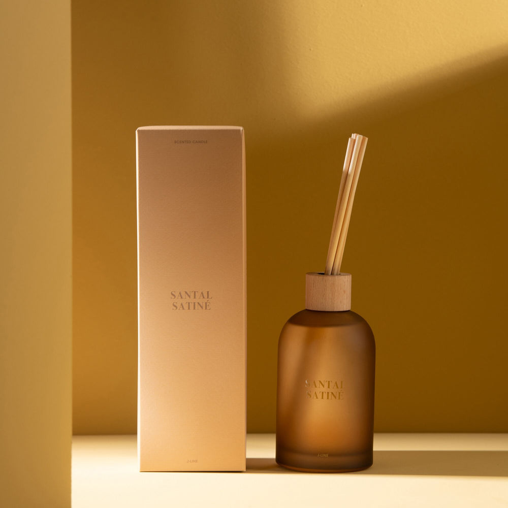 Lifestyle image of the Santal Satiné Diffuser displayed in a warm-toned interior.