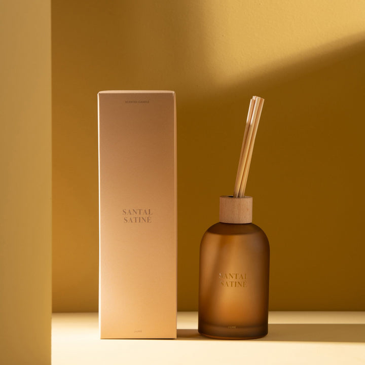 Lifestyle image of the Santal Satiné Diffuser displayed in a warm-toned interior.