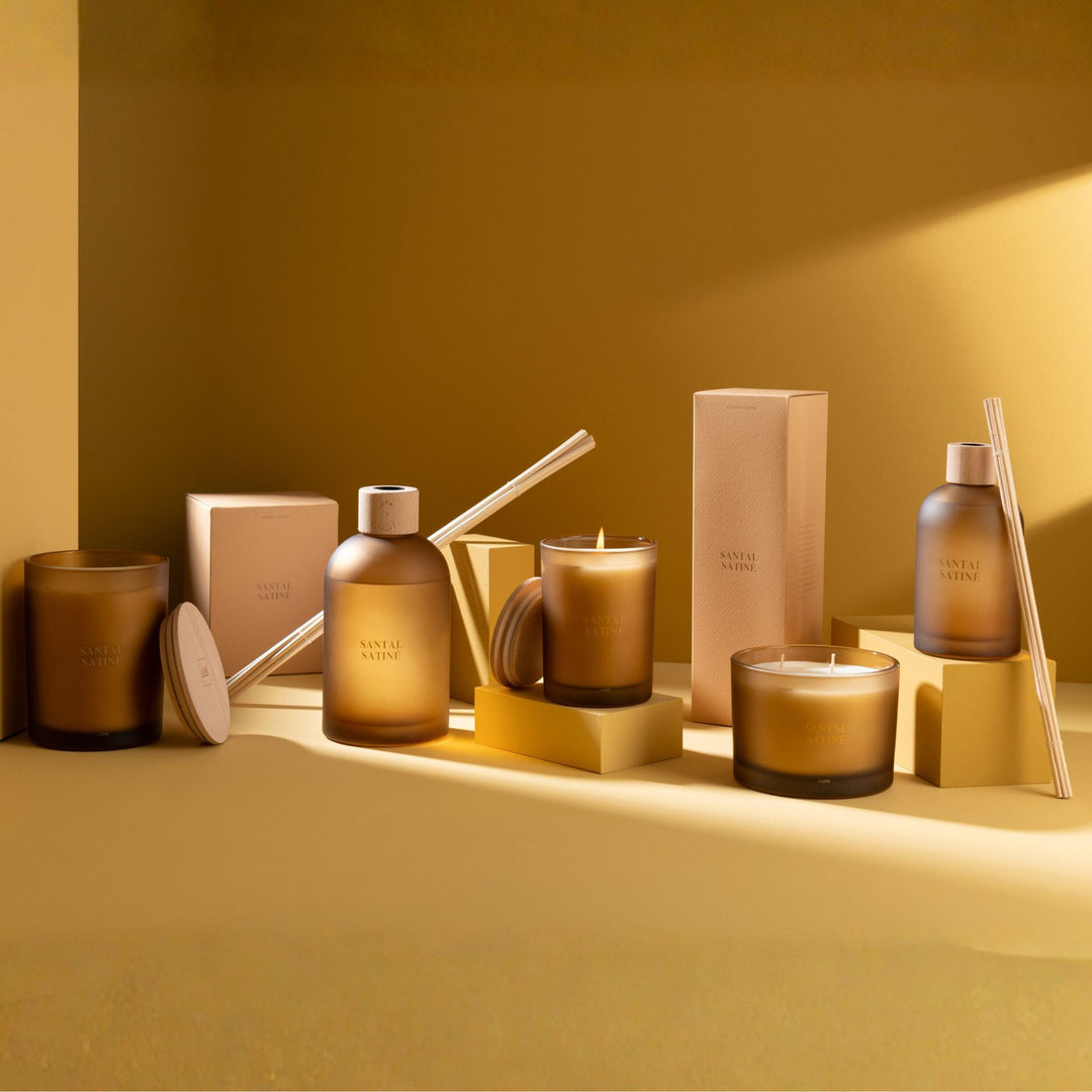 Group setting featuring the Santal Satiné home fragrance collection.