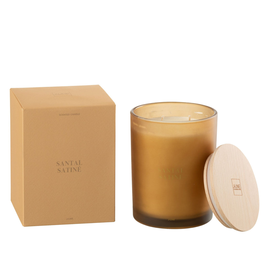 Close-up of the Santal Satiné candle showing frosted golden glass texture.