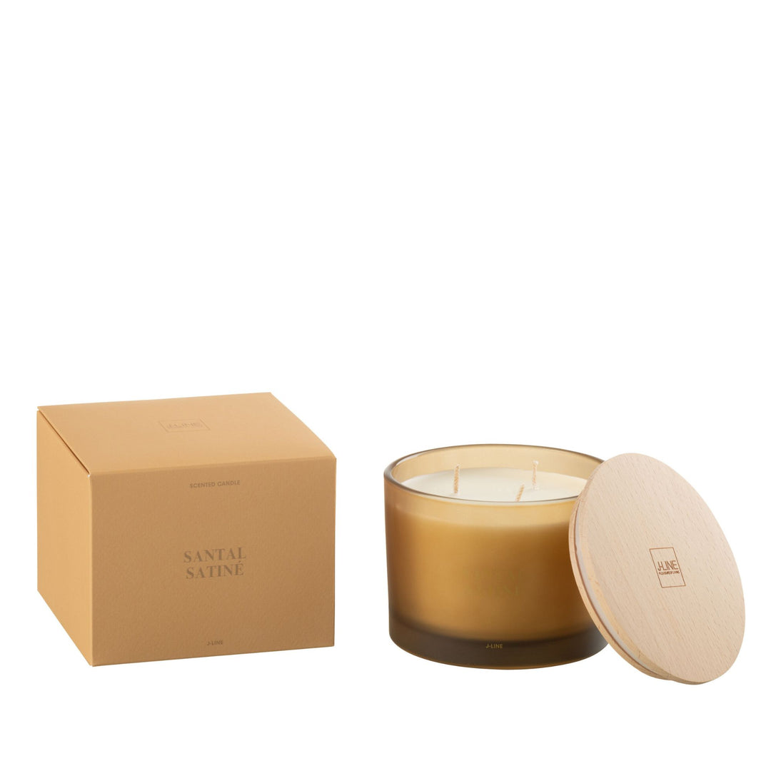Small Santal Satiné candle beside packaging in minimalist styling.
