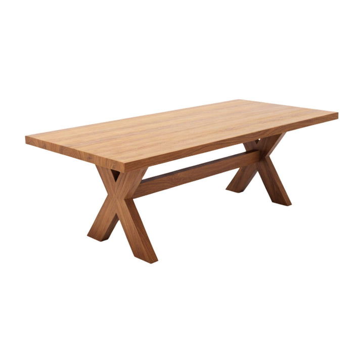 Front view of the Santorini dining table in natural teak wood with X-legs.