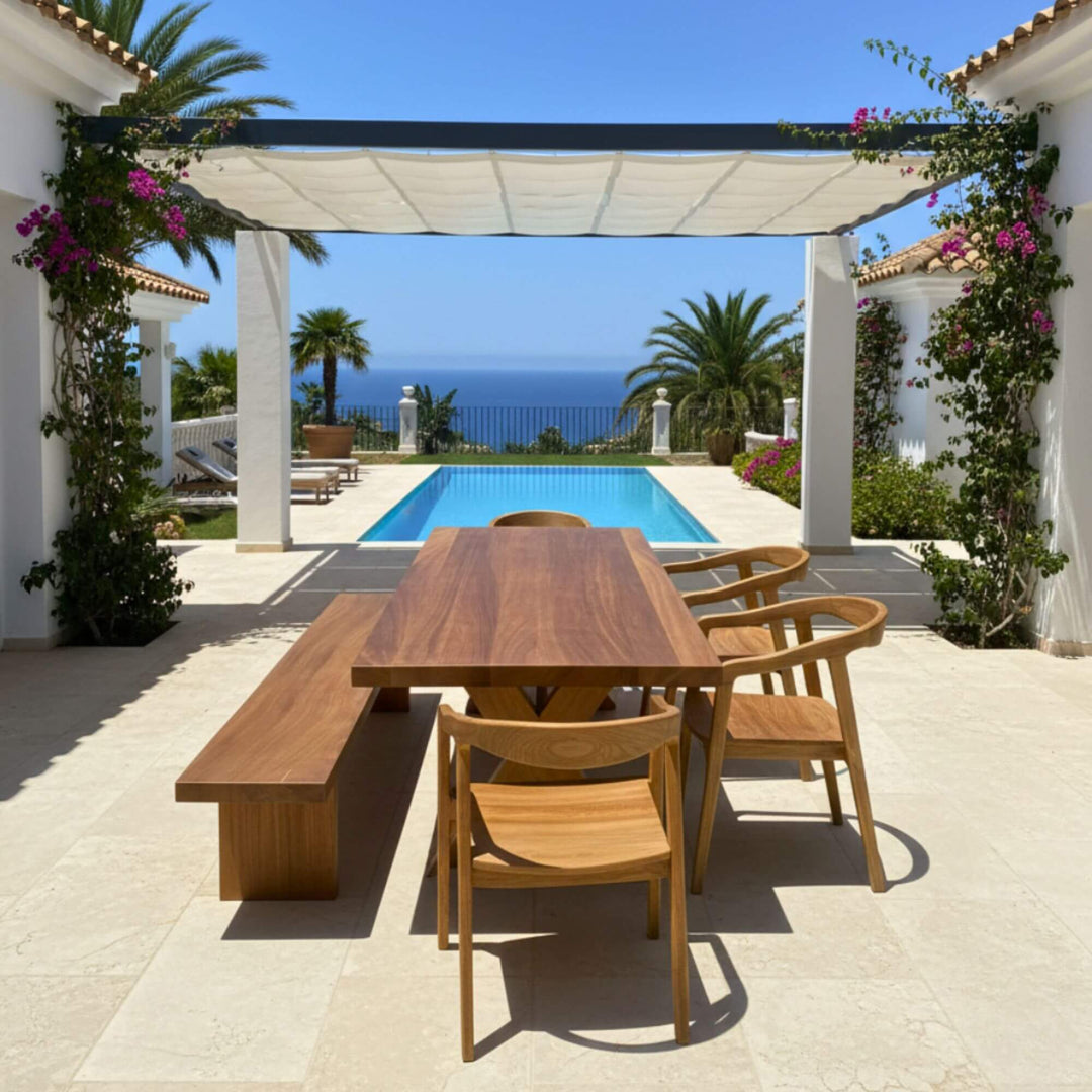 Poolside terrace scene featuring the Santorini dining table and chairs.