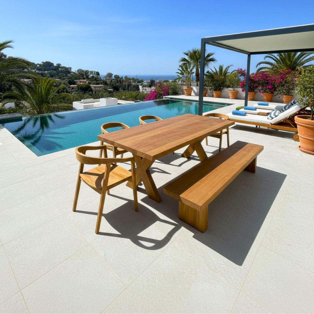 Full outdoor dining setup with the Santorini teak table under the sun.
