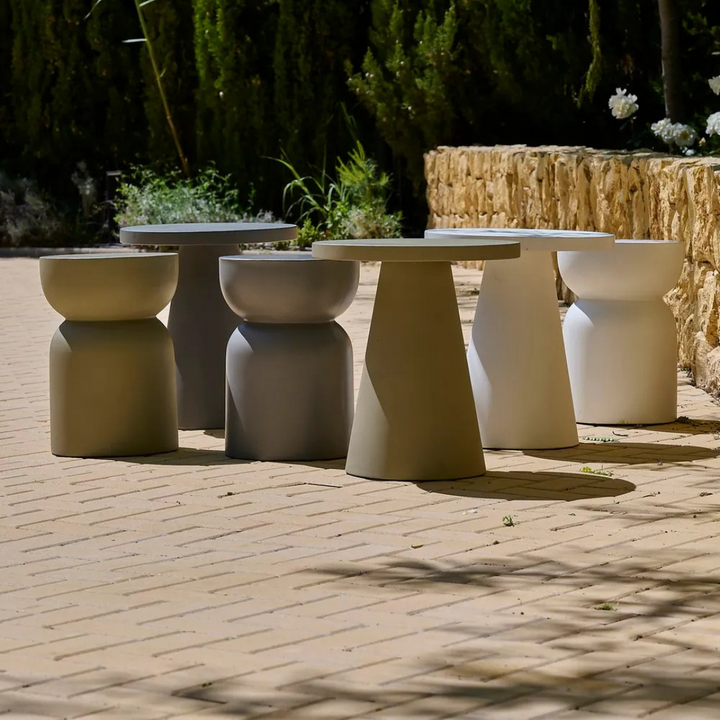 Group of San Gimignano cement stools arranged outdoors, highlighting their architectural forms.
