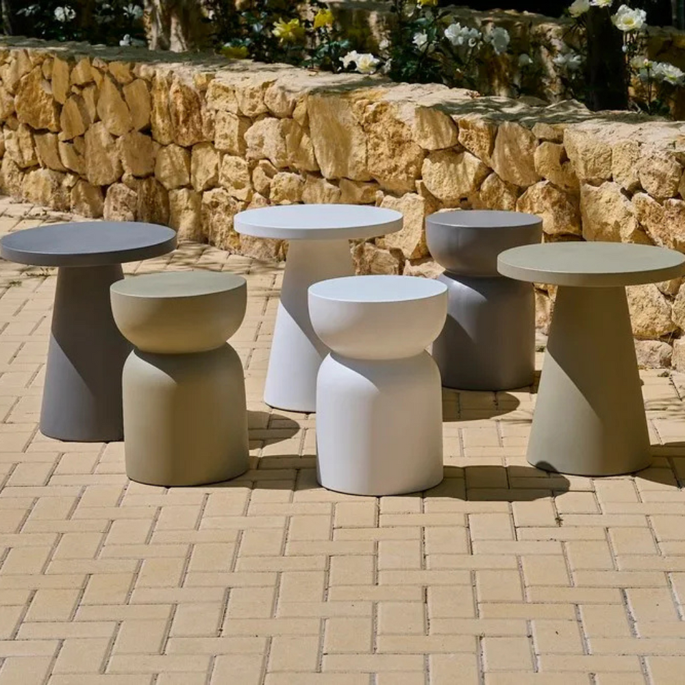 Group of San Gimignano cement stools arranged outdoors, highlighting their architectural forms.