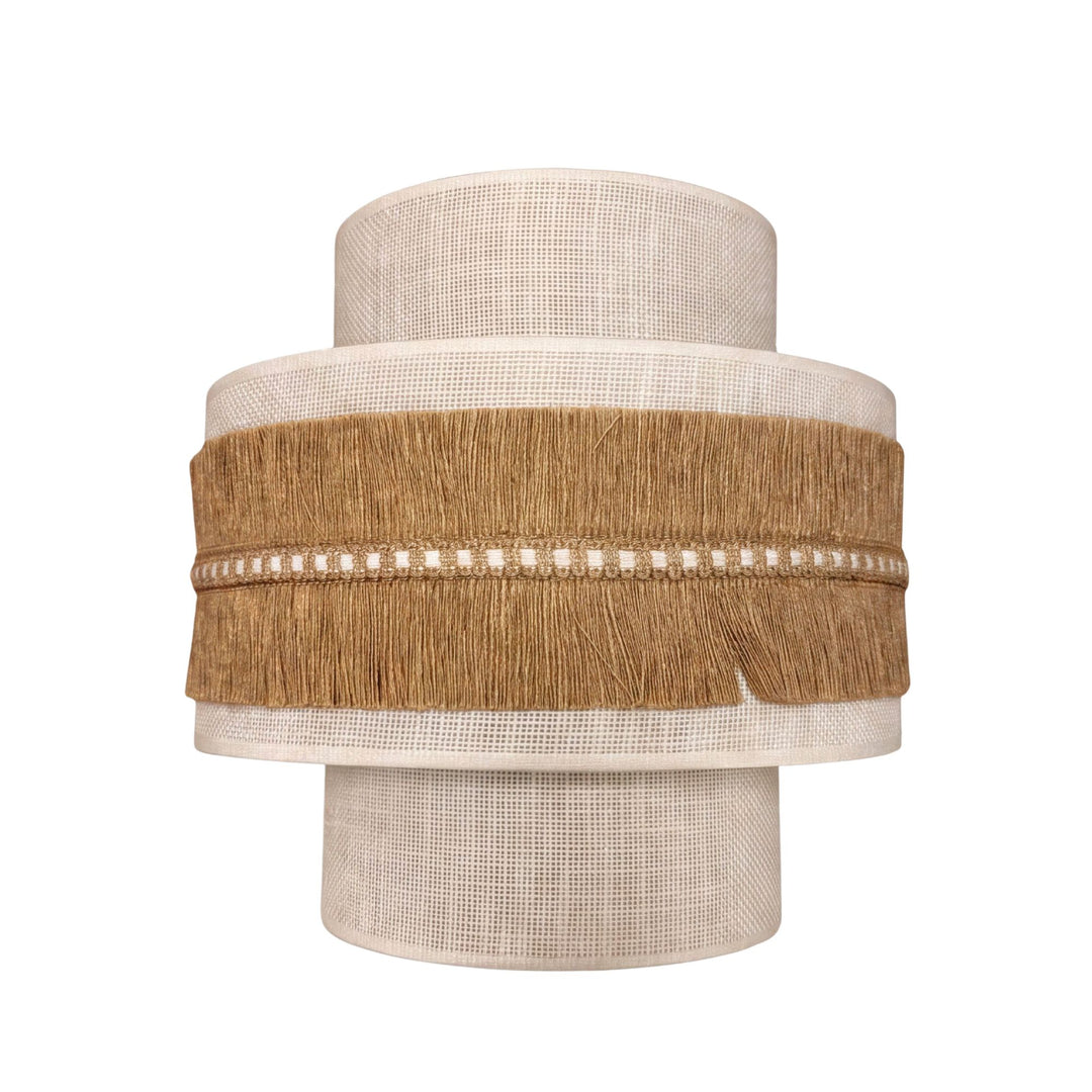 Front view of the Sapi wall lamp showing its layered fabric shade and natural jute fringe detailing.