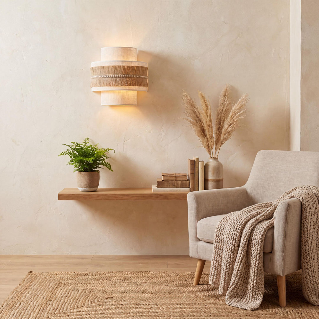 Styled interior setting featuring the Sapi wall lamp above a wooden shelf in a warm natural living space.