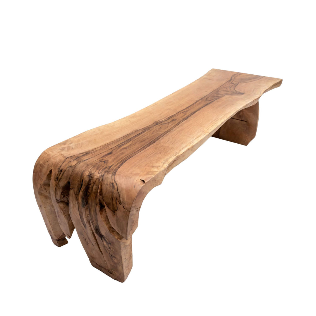 Front view of the Savara mango dining table showing its sculptural solid wood form and natural live-edge character.