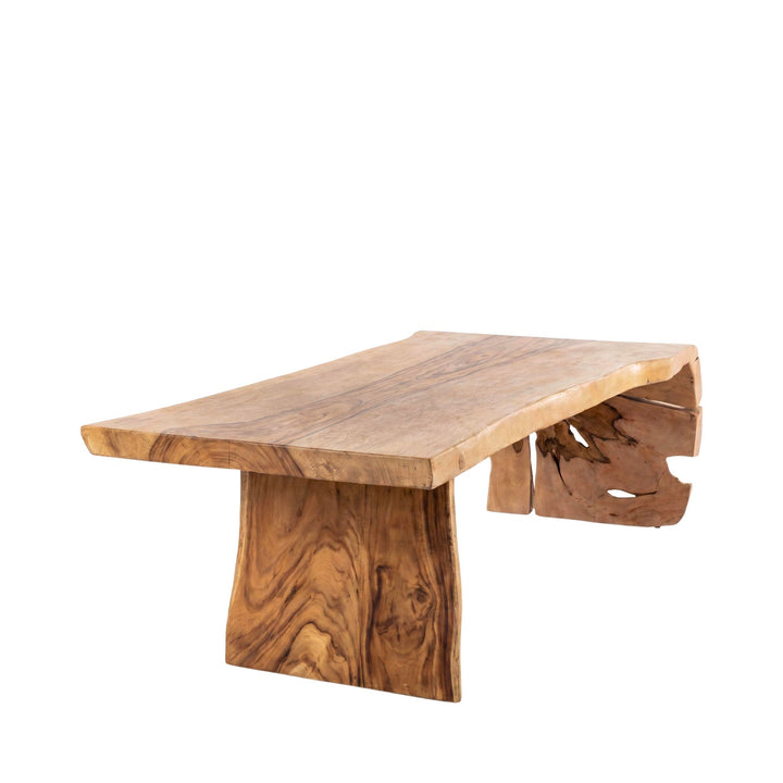Front angled view of the dining table highlighting its bold base and handcrafted organic silhouette.