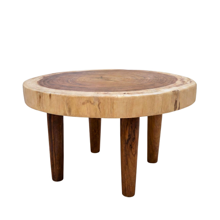 Angled view of the coffee table highlighting its compact sculptural form and rich suar wood tones.