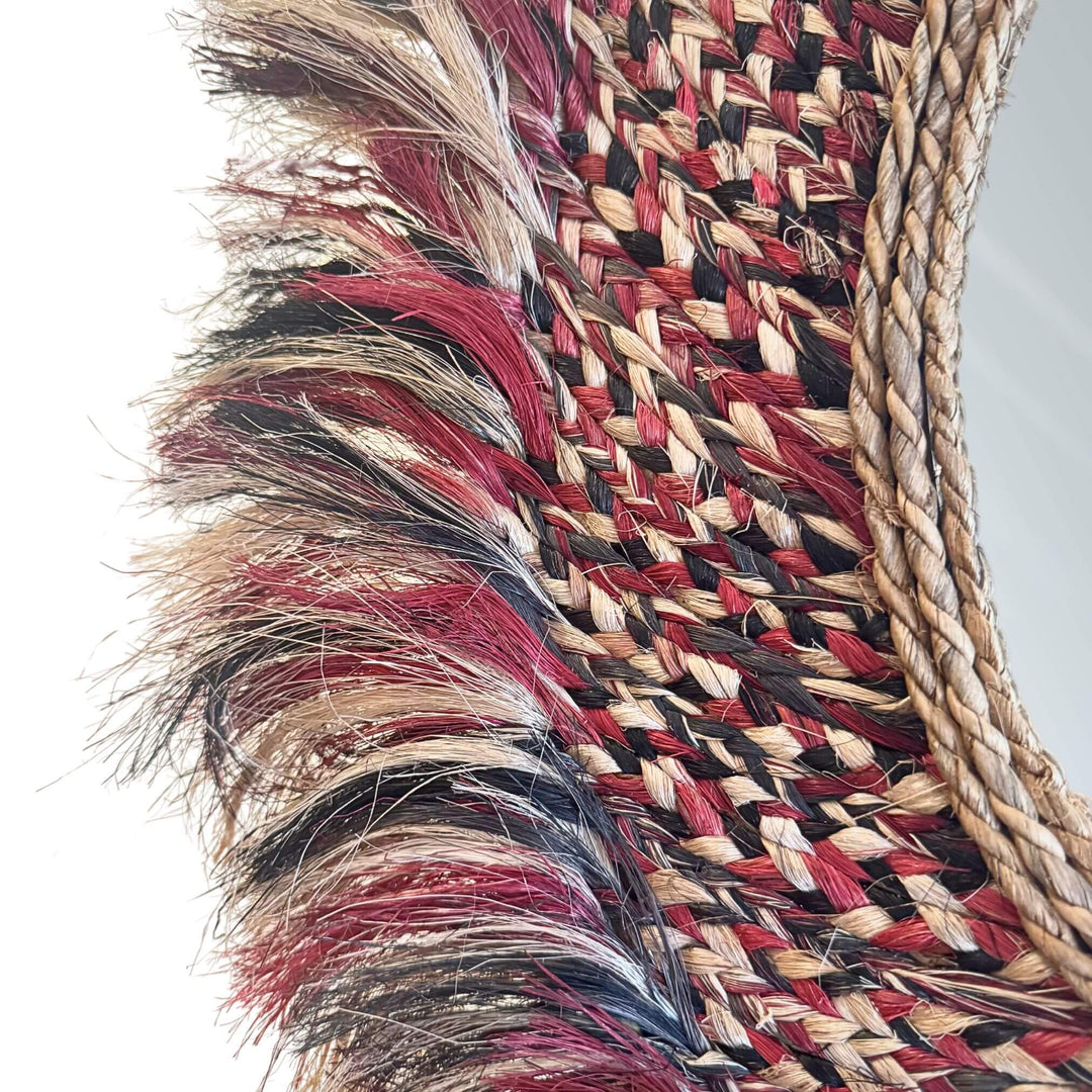 Close-up of Sawana Mirror made of abaca, sisal, and cotton with an organic frame and multicolor accents.