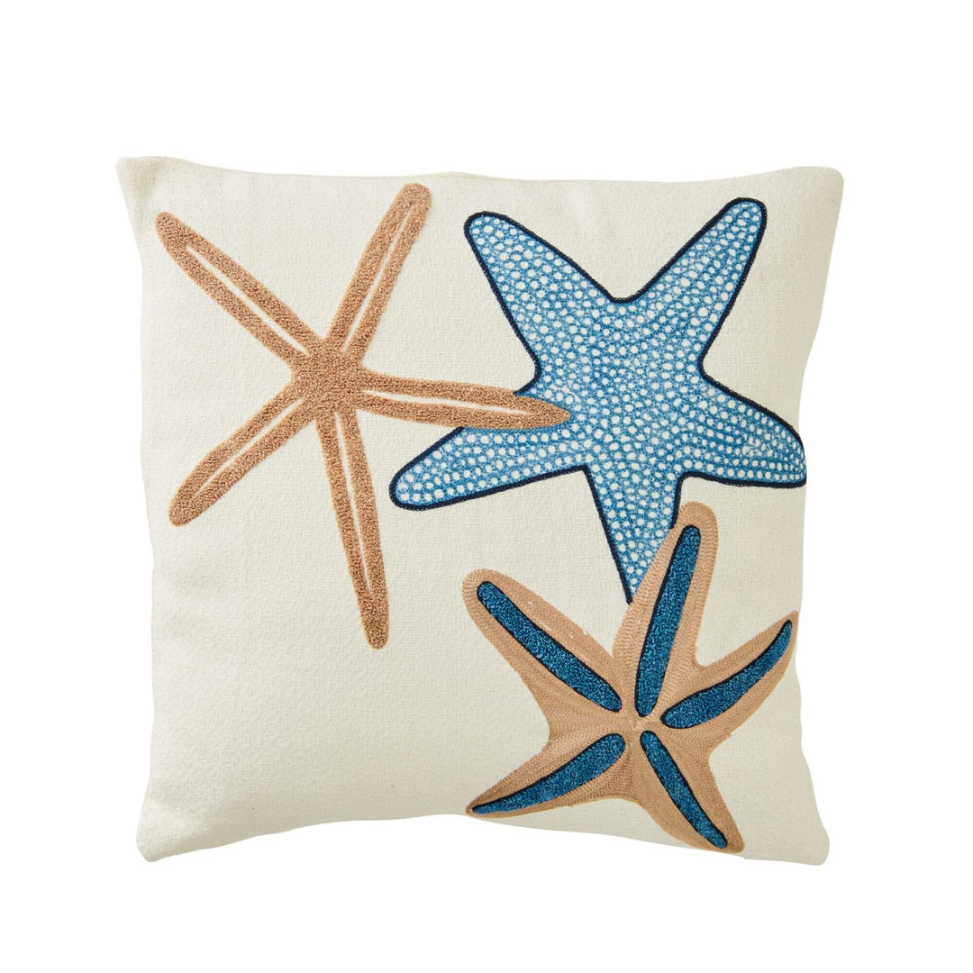 Front view of the Seastar cushion showing embroidered starfish motifs in blue and sand tones.
