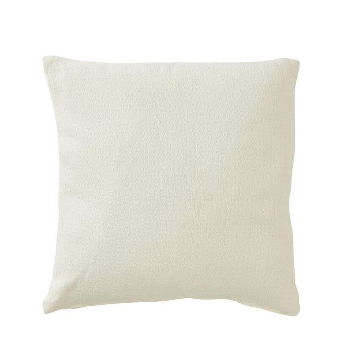 Styled coastal setting featuring the Seastar cushion on a woven chair by the sea.