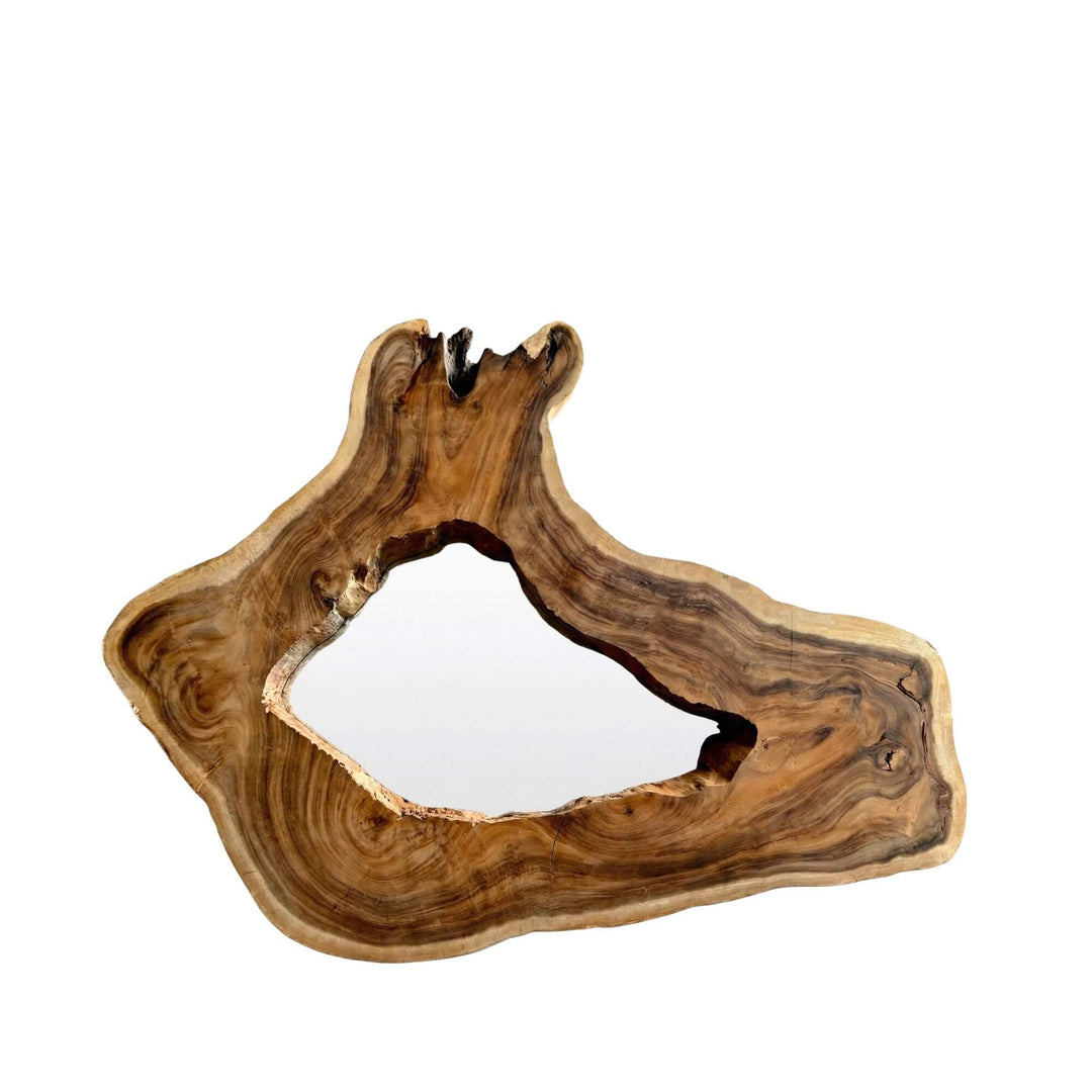 Front view of the Sebirut mirror showing its organic suar wood frame and irregular natural shape.