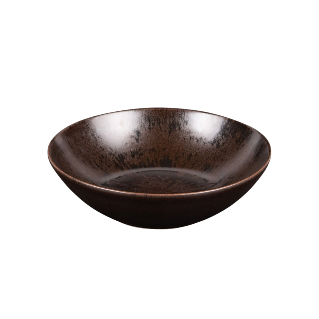 Ceramic bowl from the Sebuku Brown collection showing organic shape and finish.