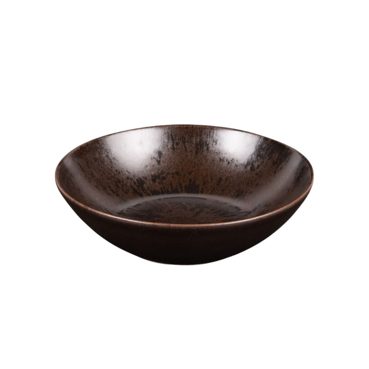 Ceramic bowl from the Sebuku Brown collection showing organic shape and finish.