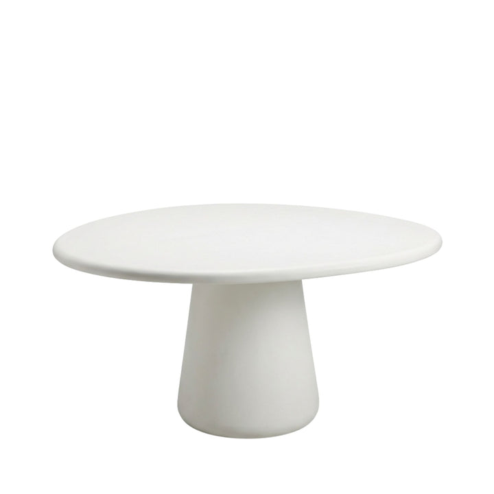 Front view of Senja microcement dining table showcasing its round top and central pedestal base.