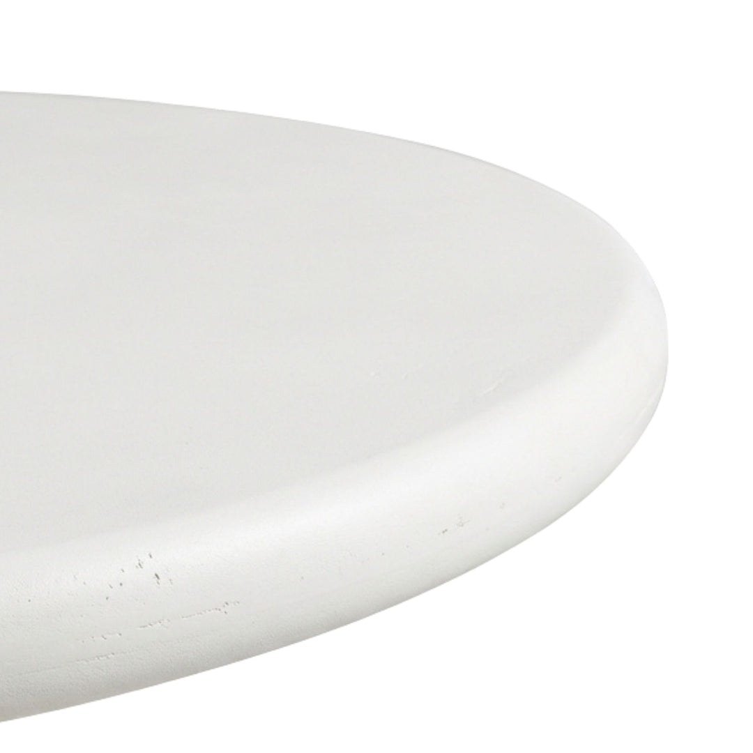 Close-up detail of the microcement tabletop highlighting its smooth texture and soft edges.