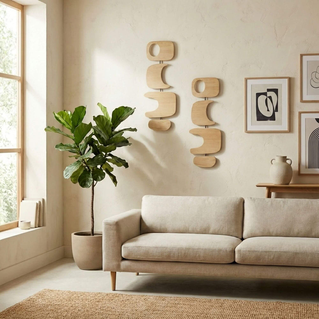 Beige sofa in a living room with decorative Senja sungkai wall art and plants