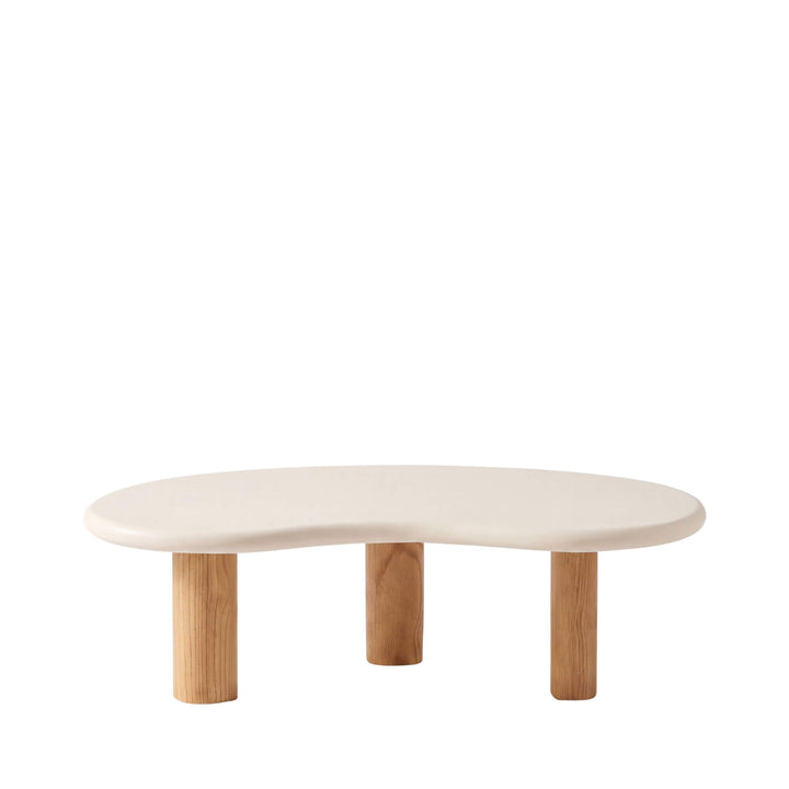 Front view of the Senja coffee table with an organic off-white microcement top and three cylindrical sungkai wood legs