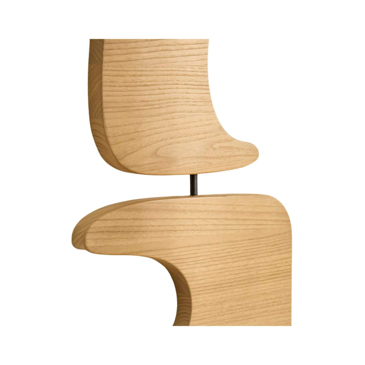 Close-up of modern sculptural wooden wall art with organic forms and smooth finish.