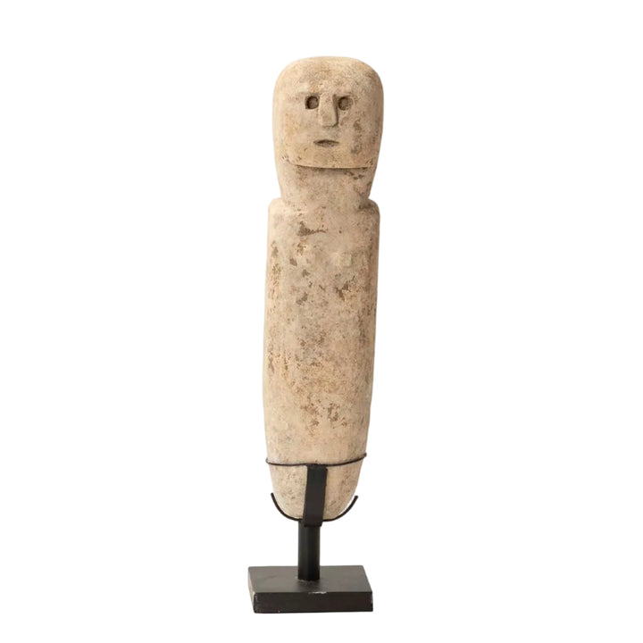 Front view of the Serkis stone sculpture highlighting primitive carved facial features.