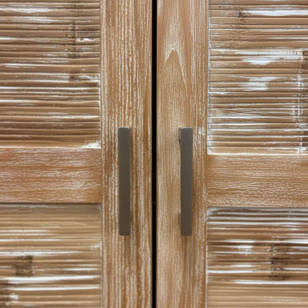 Detail of the teak door handles and textured wood surface.