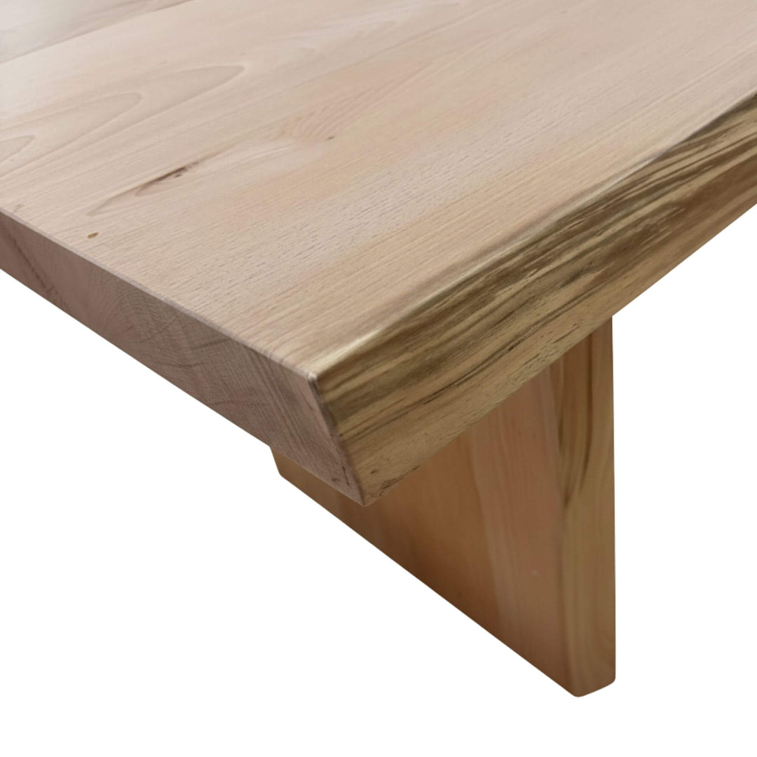 Close-up of the tabletop edge showing natural sycamore grain.