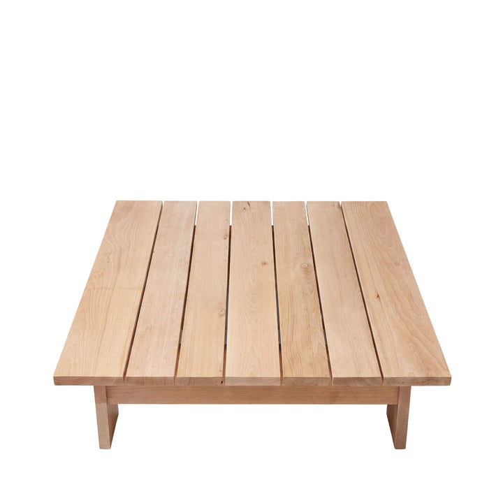 Side view of the Sicomoro coffee table showing its low profile and solid outdoor wood structure.