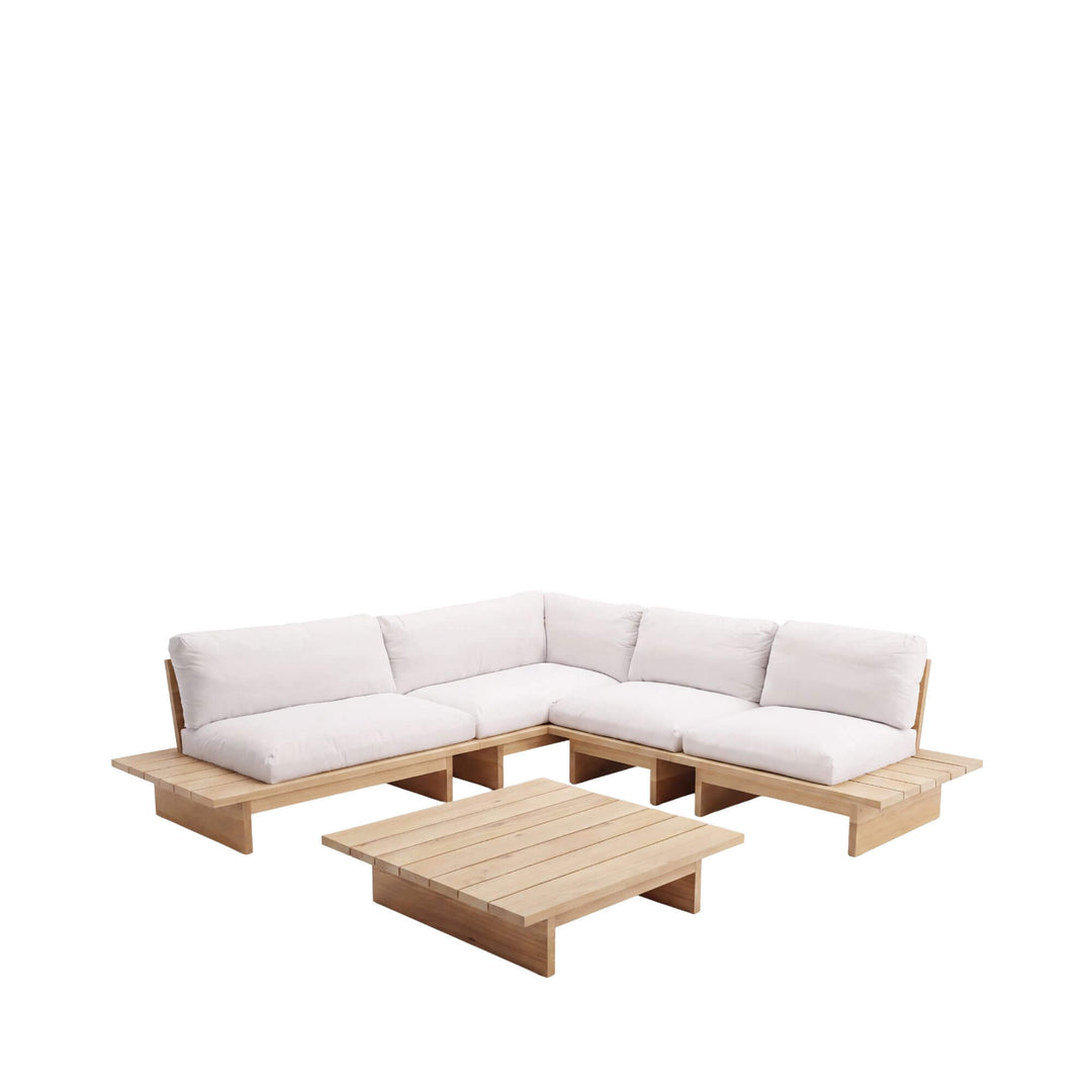 Front view of the Sicomoro outdoor sofa showing its spacious corner layout, natural wood frame, and neutral cushions.