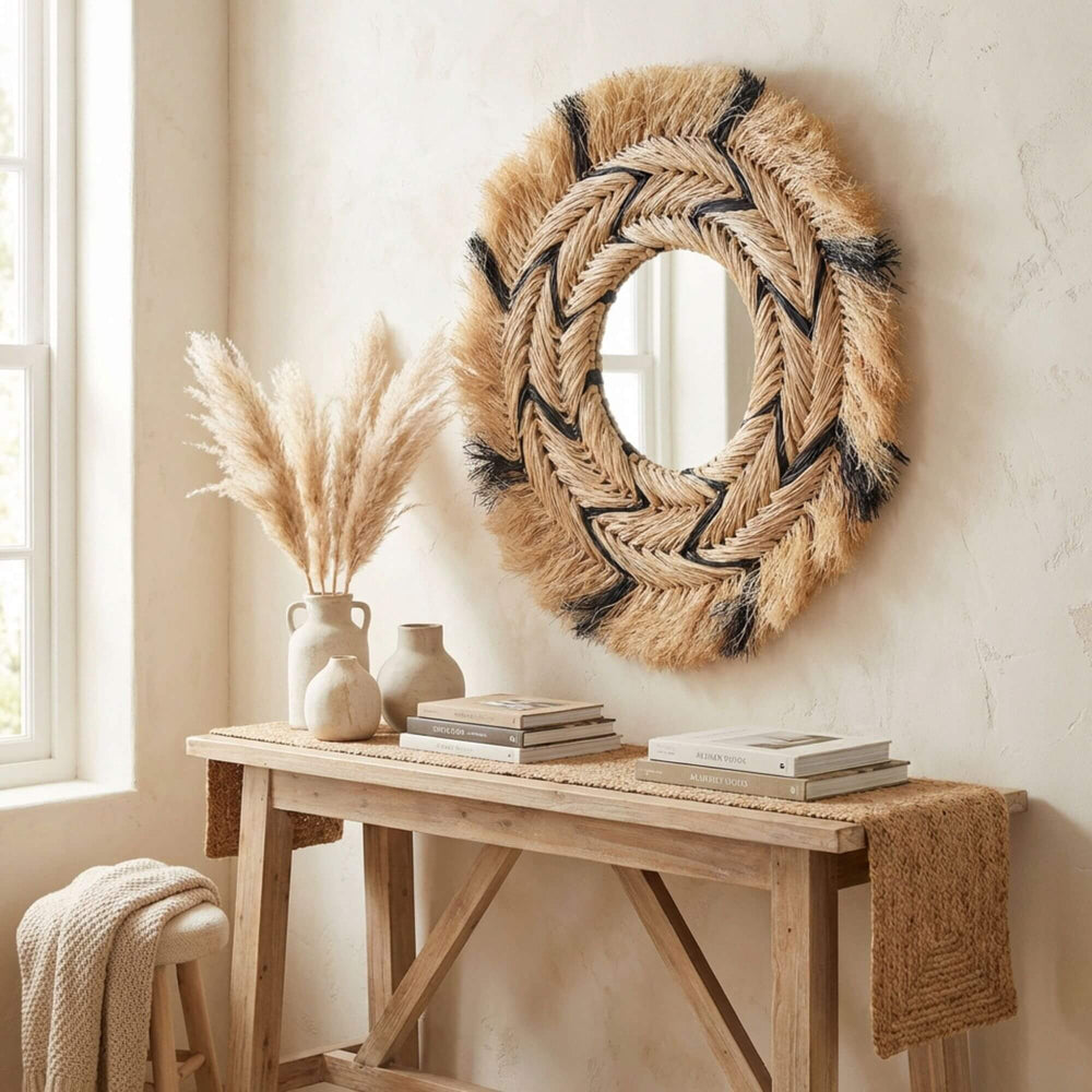 Styled interior setting featuring the sisal round mirror above a wooden console table.