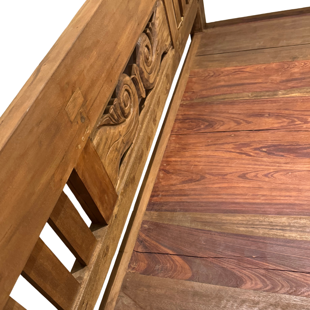 Close-up detail of Skopelos bench seat and carved wooden backrest texture.