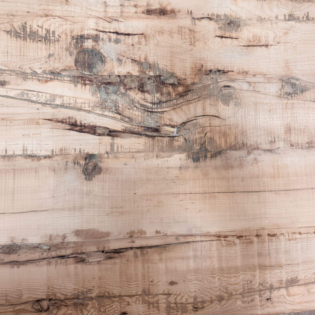 Close-up of a wooden surface of Sleeper rail train dining table with visible grain and texture