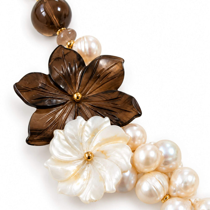 Close-up of brown and ivory carved mother-of-pearl flowers with natural pearls