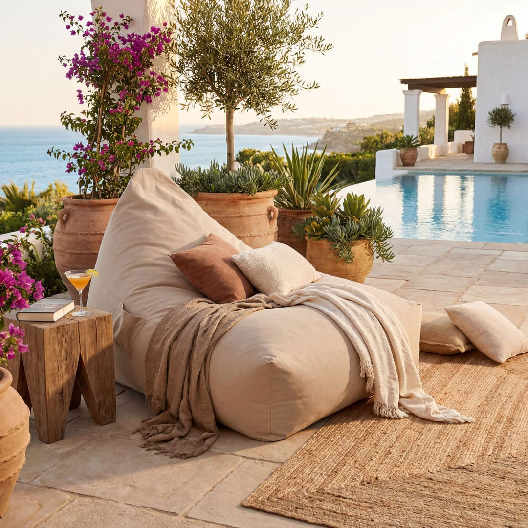 Styled outdoor setting featuring the Soma beanbag placed on a terrace near a pool.