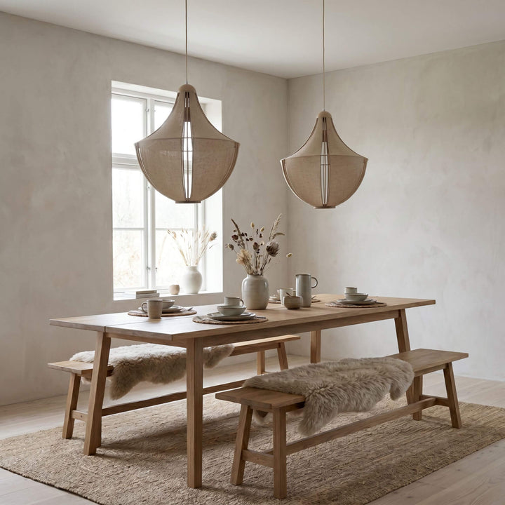 Styled dining room setting featuring the Sora pendant lamps suspended above a wooden dining table.